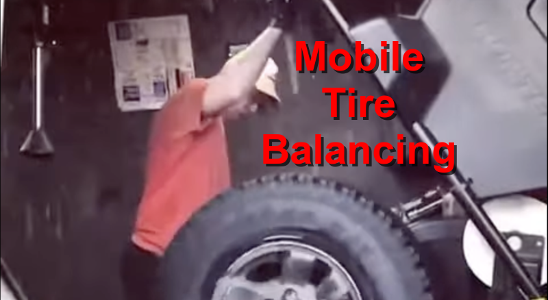 Tire Guy Clark changing tires on a 4-runner in the rain